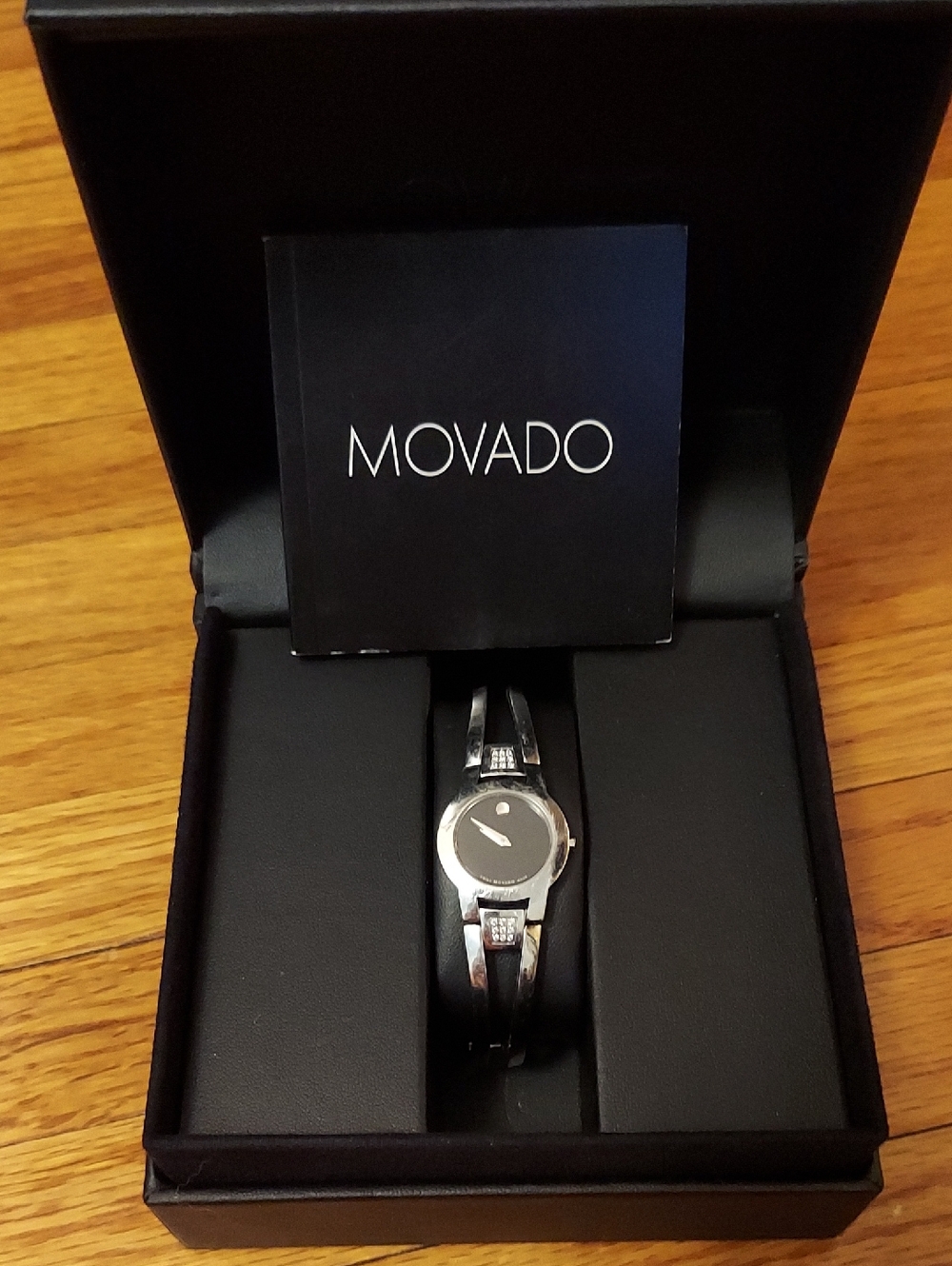 Movado Silver Tone Bracelet Watch with Black Dial With Box.